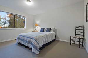 Carpeted bedroom featuring baseboards