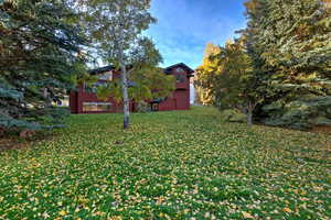 View of side of home with a lawn