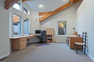 Office with healthy amount of natural light and light carpet