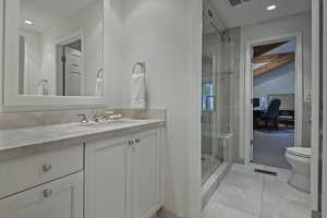 Full bathroom featuring recessed lighting, vanity, a stall shower, and light tile patterned floors