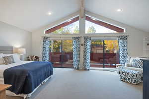 Bedroom with carpet flooring, multiple windows, and access to exterior