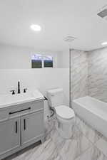 Full bath with vanity, light marble finish floors, bathing tub / shower combination, and recessed lighting