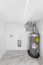 Utility room featuring strapped water heater
