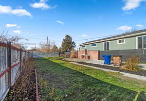 Fenced backyard with a patio area