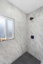 Full bath with a tile shower