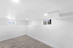 Below grade area with carpet flooring and recessed lighting