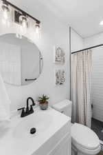 Bathroom featuring a shower stall and vanity