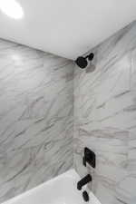 Bathroom view of shower / tub combination