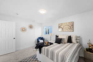 Bedroom featuring carpet flooring and baseboards