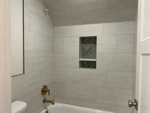 Bathroom with shower / tub combination and toilet