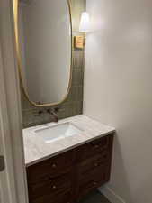 Bathroom with vanity and decorative backsplash