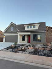 View of front facade featuring board and batten siding, concrete driveway, a garage, and a porch