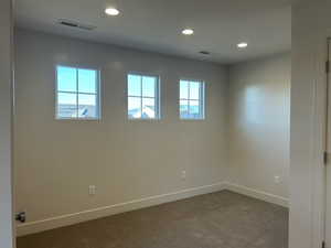 Spare room featuring carpet floors and recessed lighting