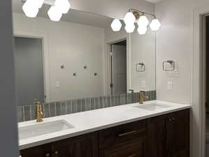 Bathroom with double vanity and toilet