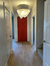 Hall with light wood-type flooring and stairway