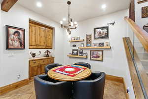 Recreation room featuring a chandelier, light tile patterned floors, and recessed lighting