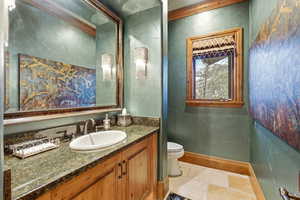 Half bathroom featuring vanity and baseboards