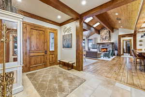 Foyer featuring a stone fireplace