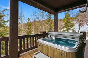 Deck featuring a hot tub and grilling area
