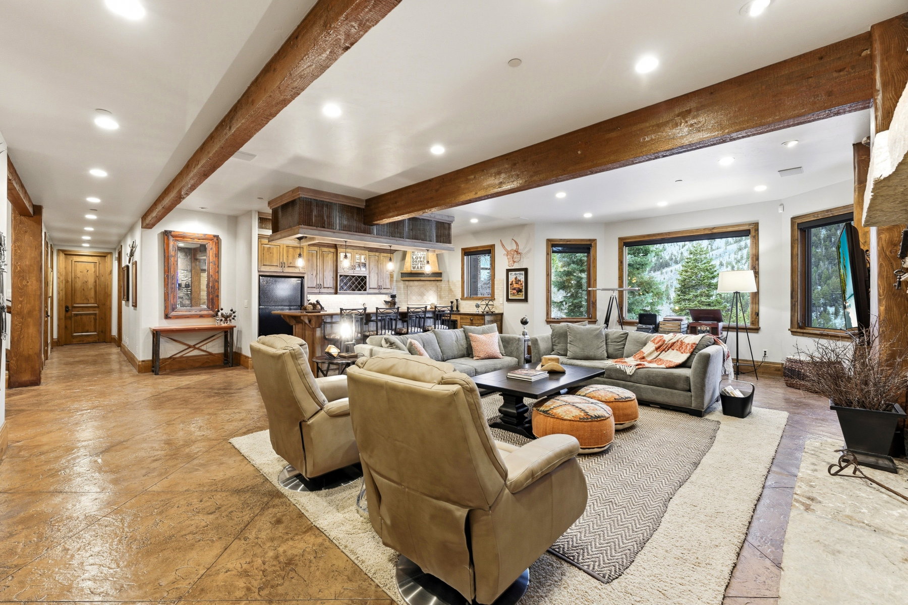 Living area featuring beamed ceiling and recessed lighting