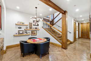 Dining space featuring stairs, a chandelier, and recessed lighting