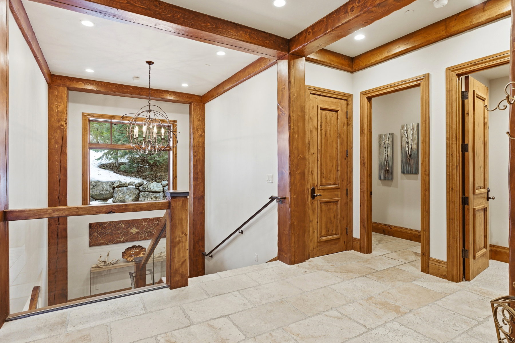 Hall with an upstairs landing, stone tile floors, a chandelier, recessed lighting, and beam ceiling