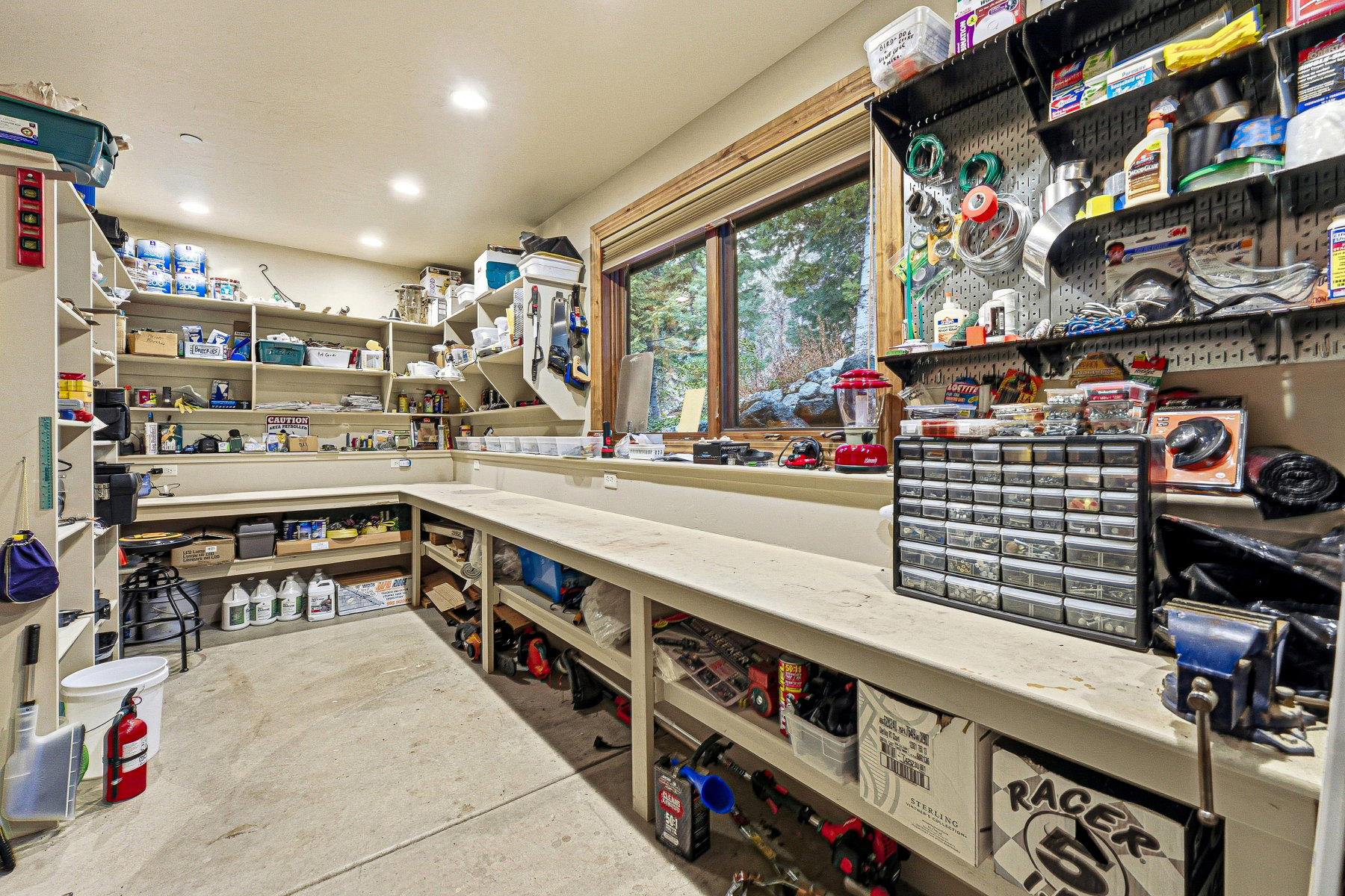 Misc room featuring a workshop area, unfinished concrete floors, and recessed lighting