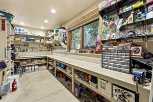 Misc room featuring a workshop area, unfinished concrete floors, and recessed lighting