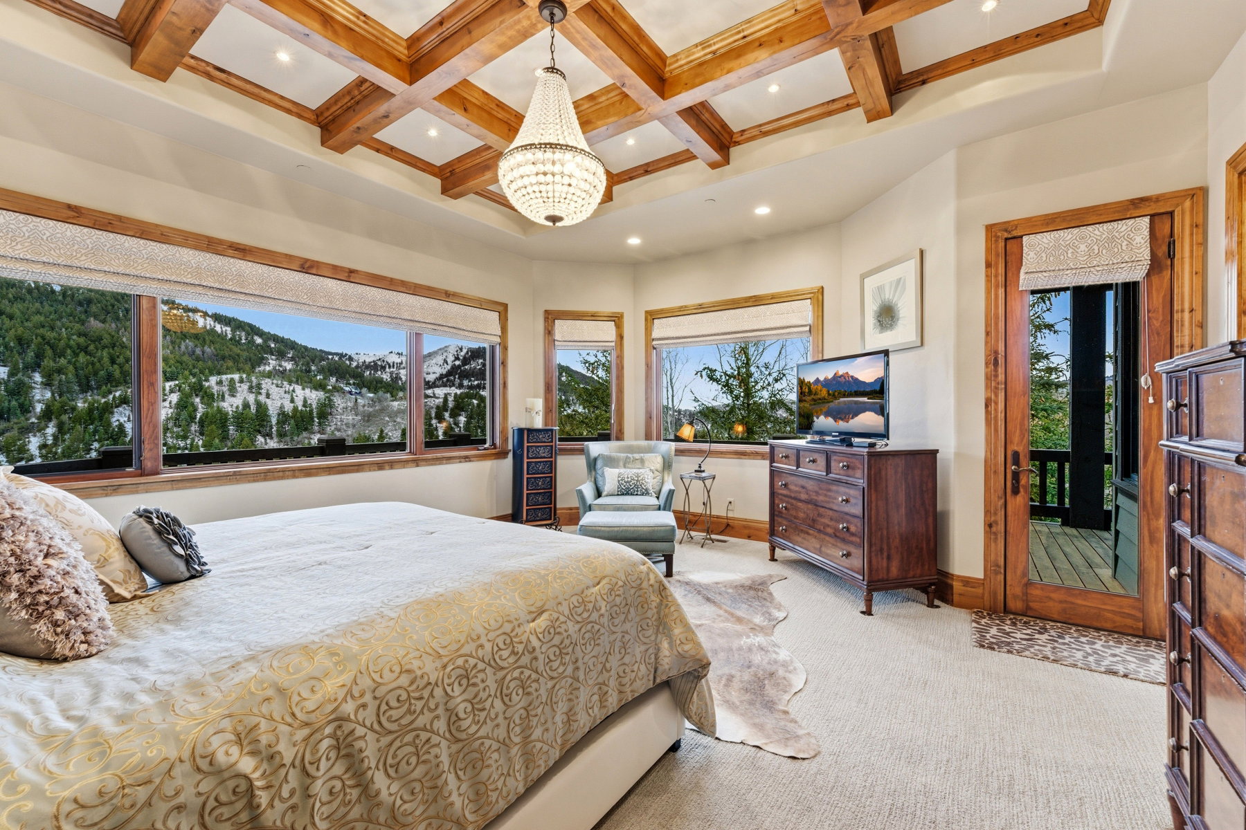 Bedroom with carpet flooring, a chandelier, coffered ceiling, multiple windows, and recessed lighting