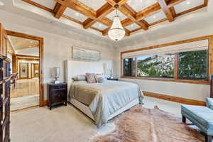 Bedroom with a chandelier, coffered ceiling, beam ceiling, and recessed lighting