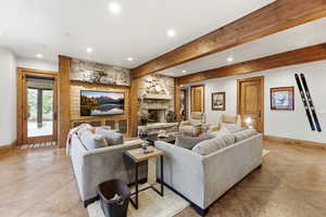 Living area featuring a fireplace, recessed lighting, and beamed ceiling