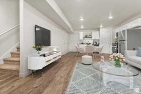 Living room with stairway, wood finished floors, and recessed lighting