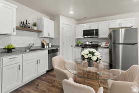 Kitchen with white cabinets, stainless steel appliances, open shelves, and recessed lighting