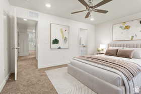 Bedroom with connected bathroom, light carpet, ceiling fan, and recessed lighting