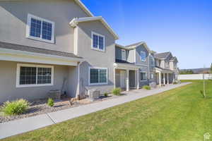 View of front of property featuring a front yard, a residential view, stucco siding, and a porch