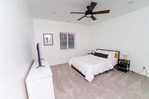 Bedroom featuring light carpet and ceiling fan