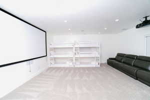 Home theater room featuring light colored carpet and recessed lighting