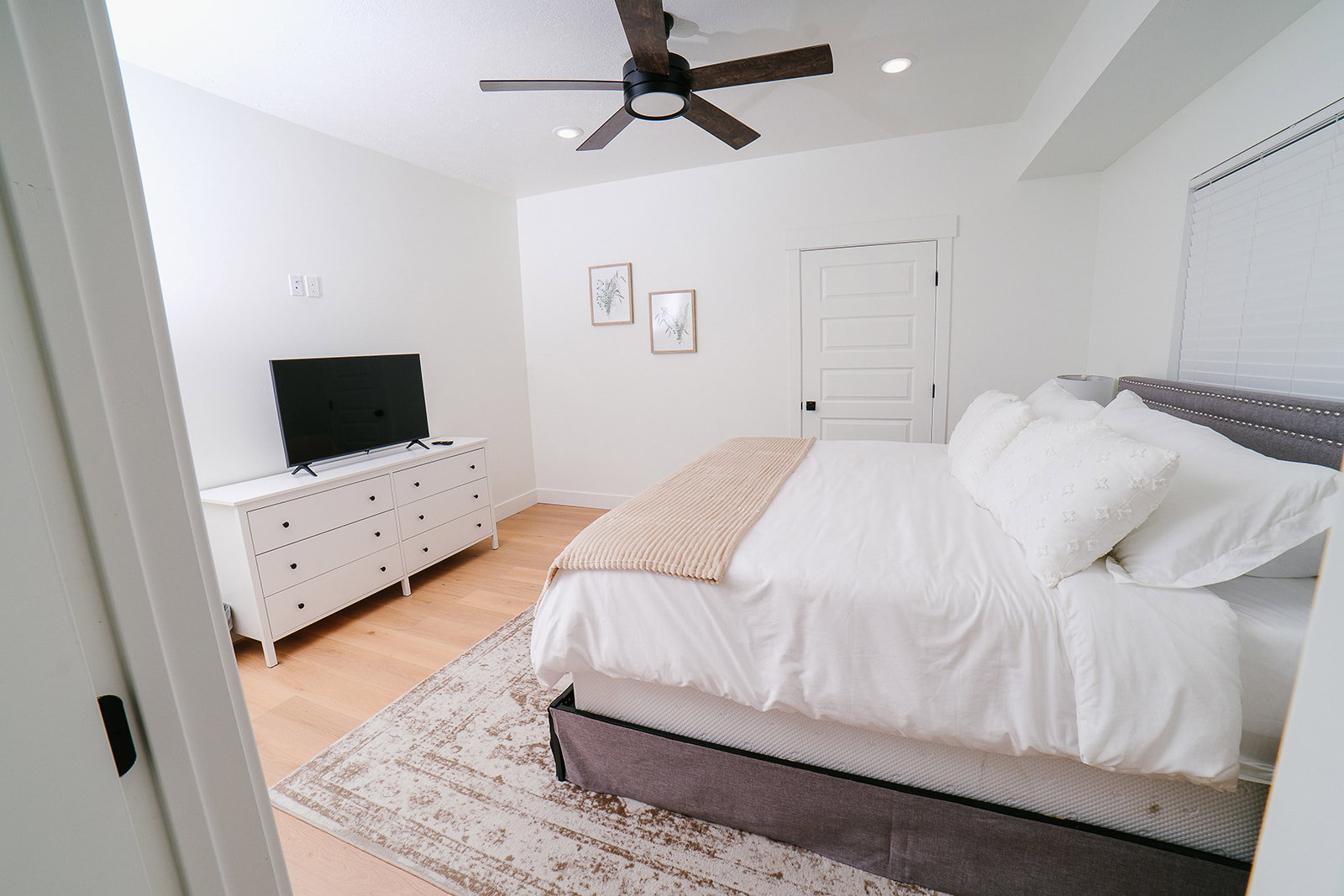 Bedroom with light wood-style flooring, a ceiling fan, and recessed lighting