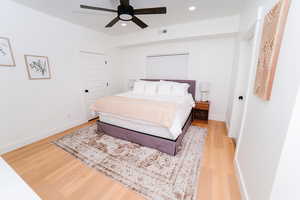 Bedroom featuring light wood-style floors, a ceiling fan, and recessed lighting