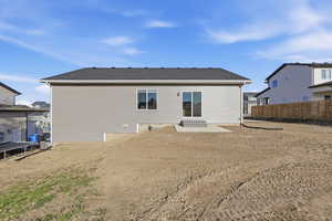 Rear view of property featuring a patio area and roof with shingles
