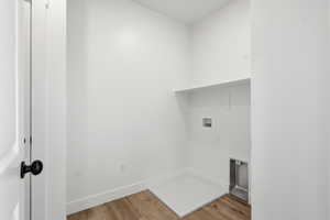 Laundry area featuring wood finished floors and hookup for a washing machine