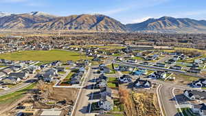 Aerial overview of property's location featuring nearby suburban area and a mountain backdrop