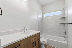 Full bath with vanity,  shower combination, and wood finished floors
