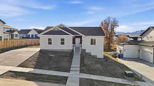 View of front of property featuring roof with shingles and driveway