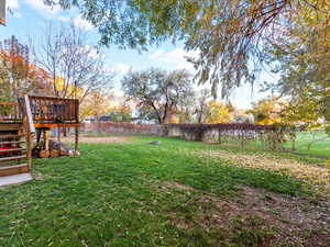 Fenced backyard featuring stairs and a deck