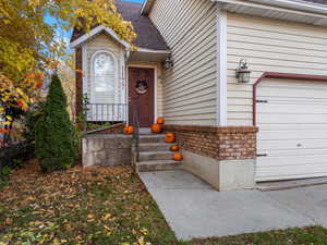 Entrance to property with a shingled roof