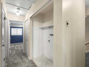Laundry room featuring carpet flooring and tile patterned floors