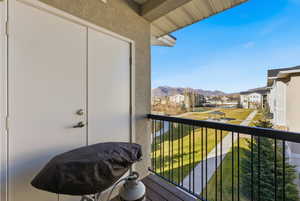 Balcony featuring a residential view and a mountain view