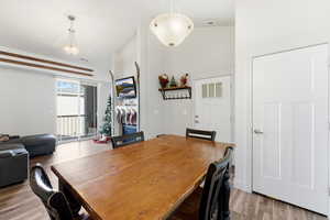 Dining room with wood finished floors and lofted ceiling