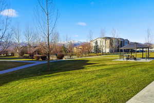 View of property's community featuring a lawn, a patio, and a gazebo